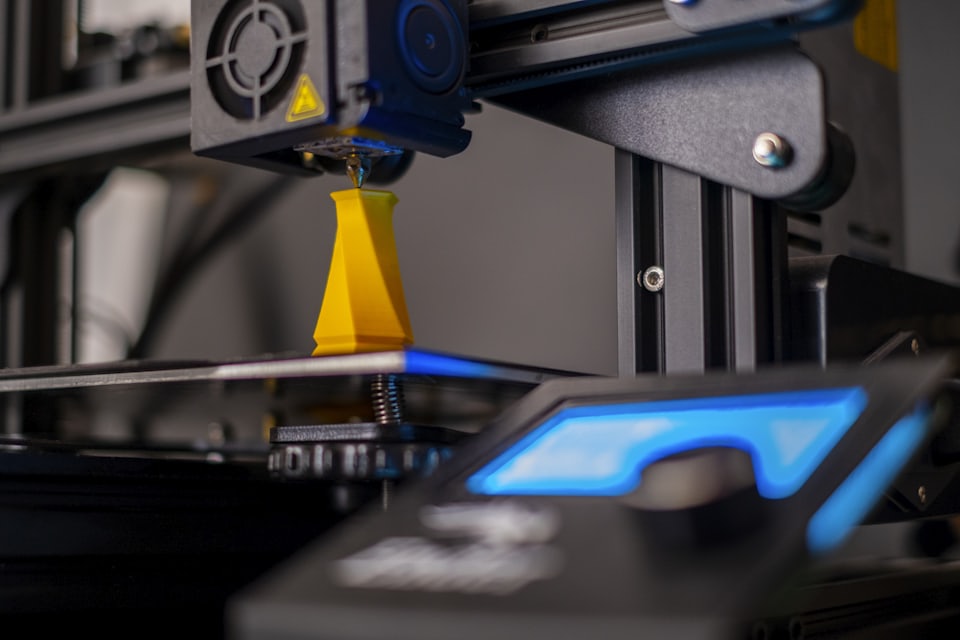 A print head extruding filament onto the build plate